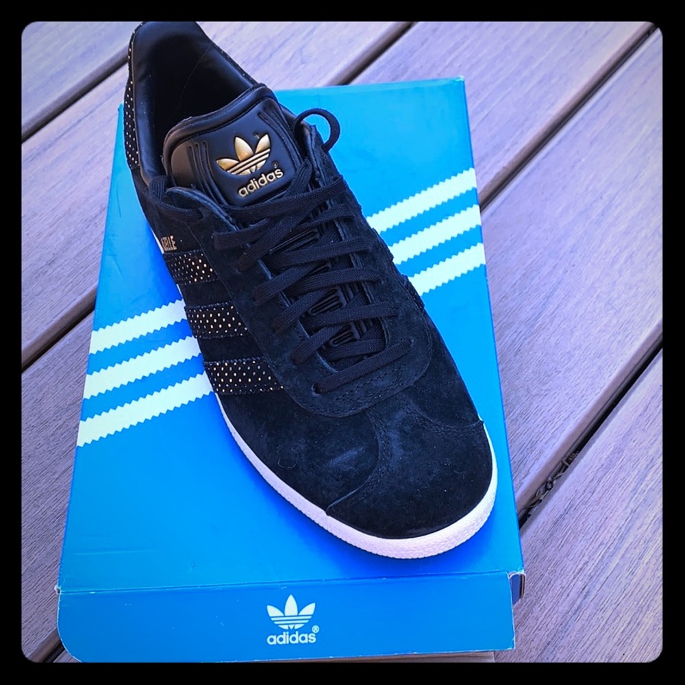Adidas black suede sneakers with gold accents